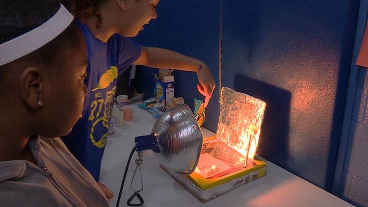 Seventh graders Tamyah Conner (left) and Bella Rollins (right) of Center for Inquiry School 27 in Indianapolis made a solar oven for the school's climate fair in March.