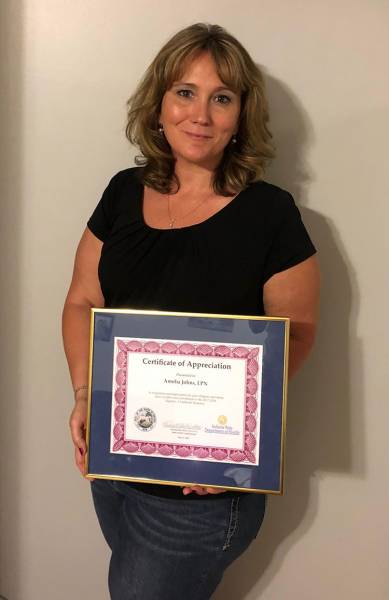Clark County Health Department nurse Amelia Johns received an award from the Indiana State Health Commissioner for her work fighting a hepatitis A outbreak in the state.