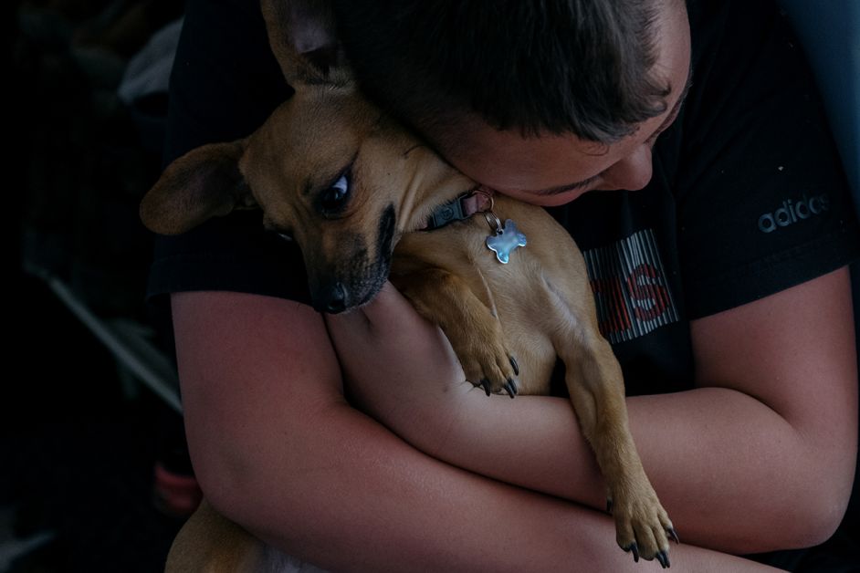 A teenager in southeast Michigan hugs his dog, the same chihuahua mix that he often taunts when he’s angry — part of the whipsaw of dramatic emotions that could be better managed with more mental health services, according to his mother, Marissa Springstead. This photo has been blurred to obscure personal information on dog tag.