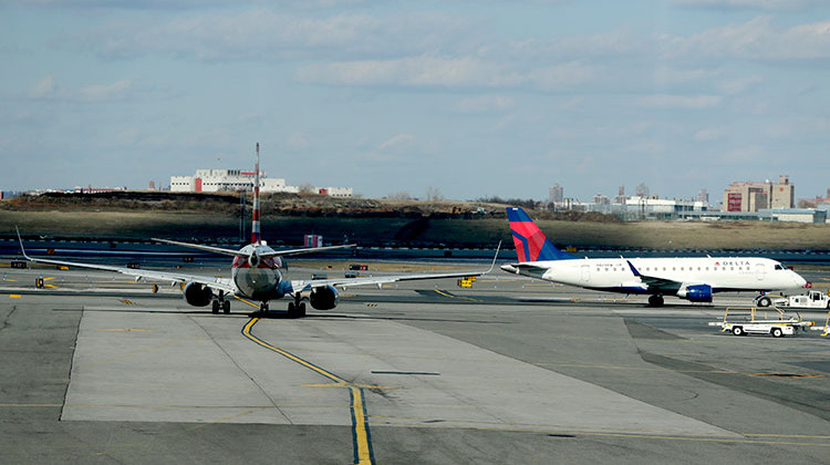 An American Airlines jet, left, waits for a Delta Airlines jet to pass by before following it onto the runway at LaGuardia Airport, Friday, Jan. 25, 2019, in New York. The Federal Aviation Administration reported delays in air travel Friday because of a "slight increase in sick leave" at two East Coast air traffic control facilities. - AP Photo/Julio Cortez