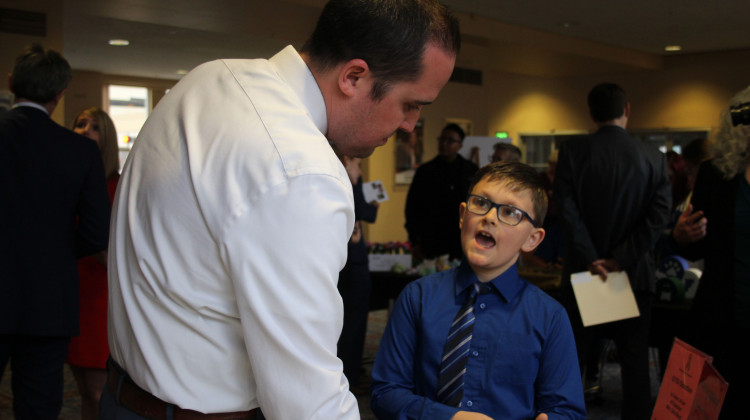 Mayflower Mill Elementary School third grader David Rowe explains his classroom's business to volunteer business judge First Merchants Bank Commercial Relationship Manager Vice President Greg Whited. - Samantha Horton/IPB News