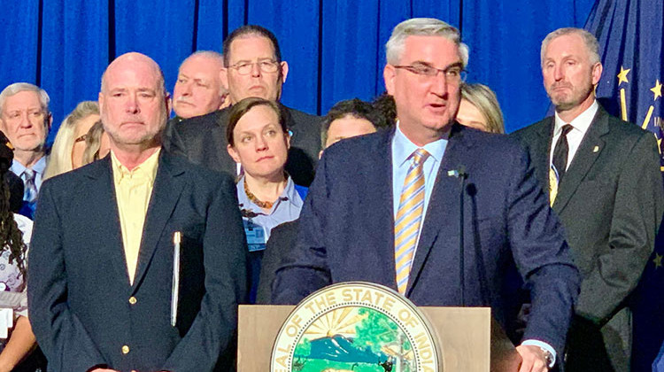 Gov. Eric Holcomb surrounded by Republican legislative leaders and state agency officials. - Brandon Smith/IPB News