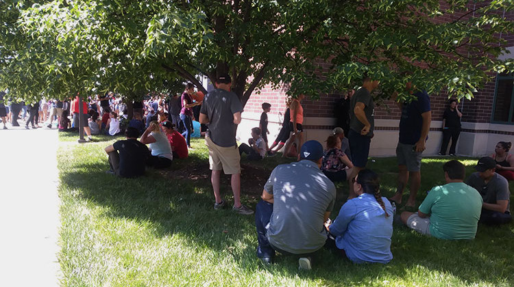 Parents wait outside Noblesville High School to pick up students evacuated from Noblesville West Middle School on Friday, May 25. - Lauren Chapman/IPB News