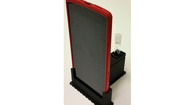 The cradle uses the phone's camera to detect low light from E. coli. - Photo courtesy of Purdue University