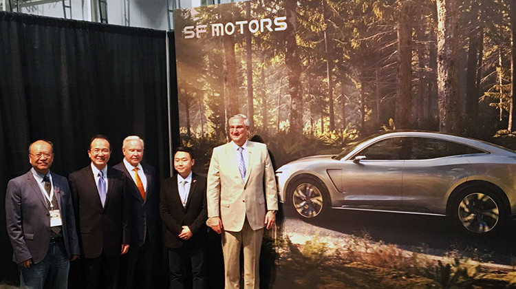 Gov. Eric Holcomb poses with Indiana Secretary of Commerce Jim Schellinger, SF Motors CEO John Zhang and other SF officials in the Mishawaka EVAP. - Jennifer Weingart/WVPE
