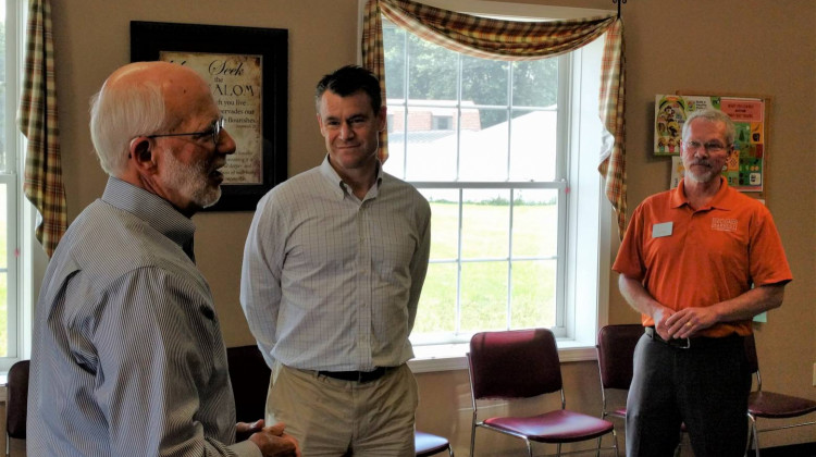 Sen. Todd Young (center) visits with area officials at The Shalom Center food pantry in Randolph County. - Stephanie Wiechmann/IPR News
