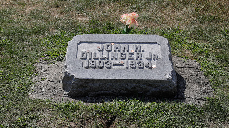 The headstone of John Dillinger is seen at Crown Hill Cemetery, Thursday, Aug. 1, 2019, in Indianapolis. Two relatives of notorious 1930s gangster John Dillinger who plan to have his remains exhumed say they have "evidence" the body buried in an Indianapolis cemetery beneath a gravestone bearing his name may not be him and that FBI agents possibly killed someone else in 1934.  - AP Photo/Darron Cummings