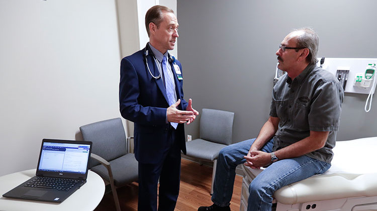 Dr. John Lynch meets with patient Jeff Thieke during his visit to the Fiat Chrysler Automotive Clinic in Kokomo, Ind., Tuesday, Sept. 4, 2018.  - AP Photo/Michael Conroy