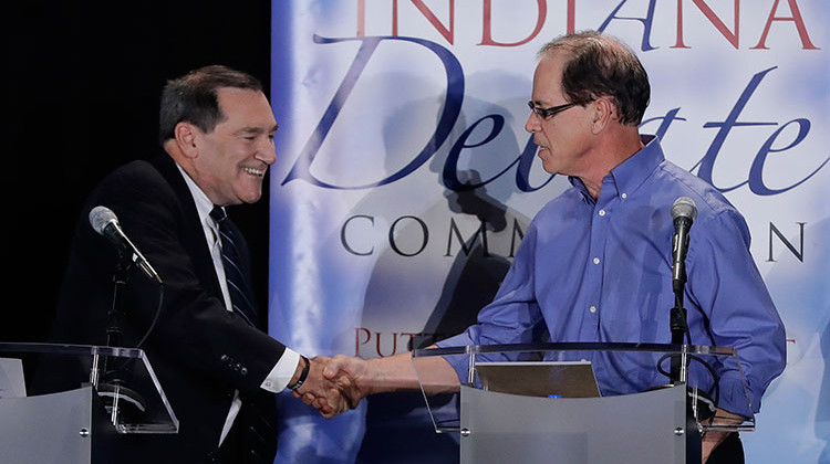 In this Oct. 8, 2018 photo, Sen. Joe Donnelly, D-Ind., left, shakes hands with Republican former state Rep. Mike Braun following a U.S. Senate Debate in Westville, Ind. Libertarian Lucy Brenton also participated in the debate. - AP Photo/Darron Cummings, Pool