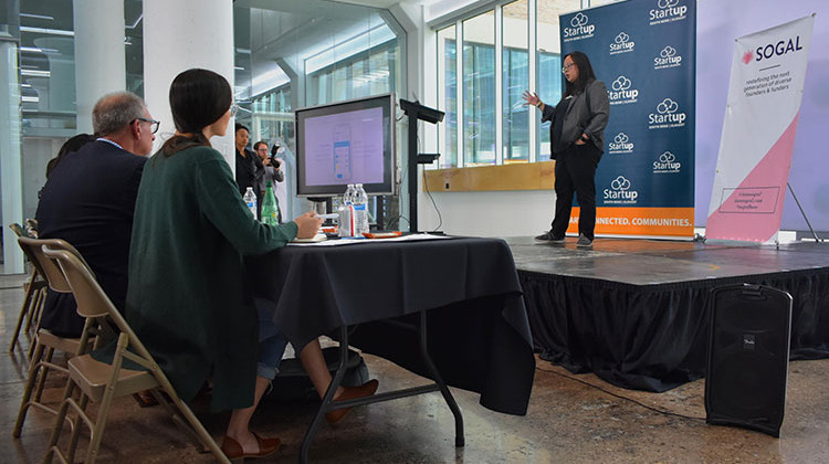 Daisy Pham of Halo App pitches her business concept of a phone application for small-dollar loans to a panel of venture capitalists.  - Justin Hicks/IPB News