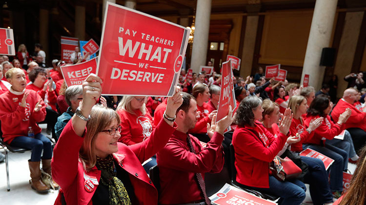 FILE - In this April 16, 2019, file photo, teachers cheer during a rally at at the Statehouse in Indianapolis. School days are being called off for tens of thousands of Indiana students as their teachers make plans for attending a union-organized Statehouse rally.