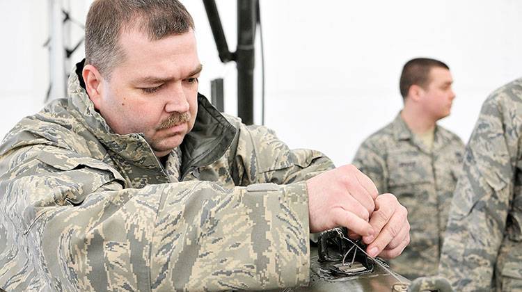 In this photo taken March 10, 2012, Technical Sgt. David Costello uses a piece of tape to date the fuse wire on a munition in Fort Wayne, Ind. The date is put on the munition to identify the when it was made. - Photo by U.S. Air Force Staff Sgt. Justin Goednen.