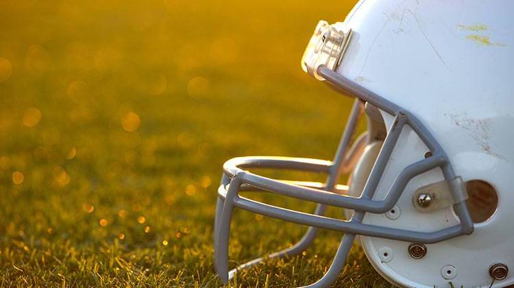 Full-pad contact at practice for Indiana's high school football teams will be limited to twice per week. - stock photo