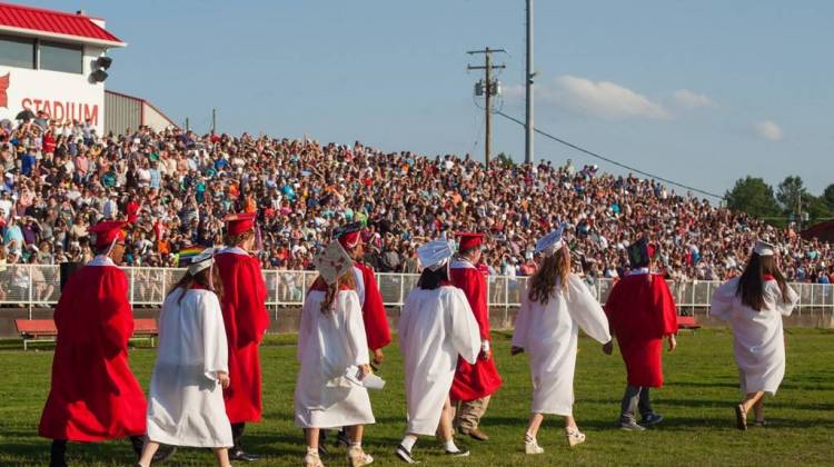 Students walk in a graduation ceremony. - Flickr