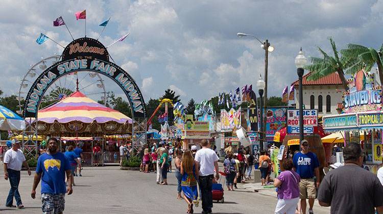 Fair-goers walk near the midway during the 2015 Indiana State Fair.  - Doug Jaggers/WFYI