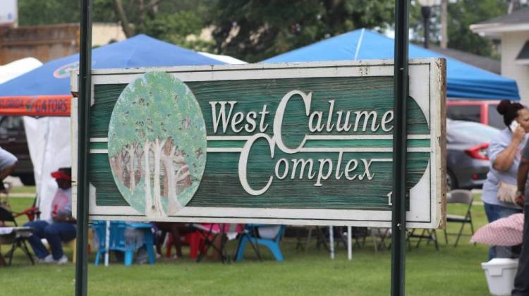 The closure of the West Calumet Housing Complex, its old sign seen here at a local block party in July, left a big hole in East Chicago's affordable housing stock that state officials now hope to help fill. - Annie Ropeik/IPB file photo