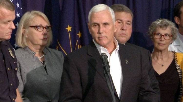 Gov. Mike Pence, shown here with members of a drug addiction task force, has been criticized by opponents for his record on public health issues. - Brandon Smith/IPBS