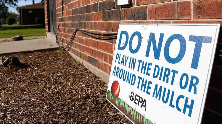 A sign from the Environmental Protection Agency is posted in front of West Calumet Housing Complex houses at East Chicago, Ind. - AP Photo/Tae-Gyun Kim