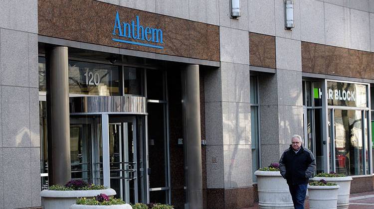 A pedestrian walks past the corporate headquarters of health insurer Anthem in Dec. 2014. - AP Photo/Darron Cummings