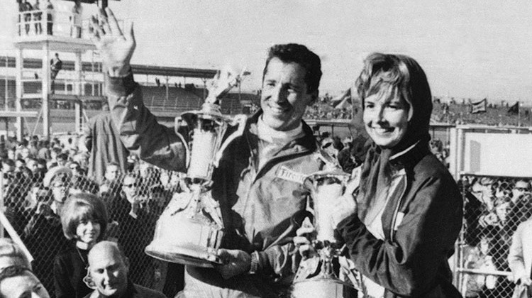 FILE - In this Feb. 26, 1967, file photo, Mario Andretti, of Nazareth, Pa., holds up his trophies with his wife, Dee Ann, after he won the Daytona 500 auto race at Daytona Beach, Fla. Dee Ann died Tuesday, July 3, 2018. She was 76.  - AP photo