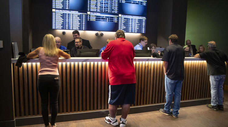 Betters line up to place wagers after sports betting became legal in Indiana at the Indiana Grand Racing & Casino in Shelbyville, Ind., Sunday, Sept. 1, 2019.  - AP Photo/Michael Conroy