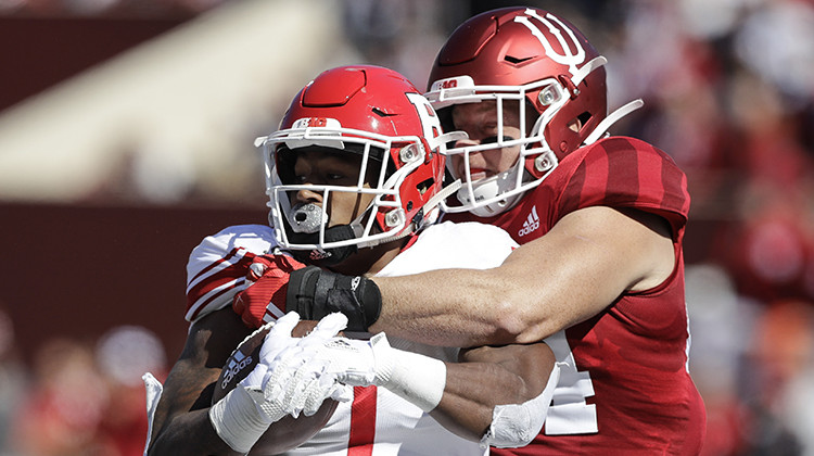 FILE - In this Oct. 12, 2019, file photo, Rutgers running back Isaih Pacheco, left, is tackled by Indiana linebacker Thomas Allen, right, during the first half of an NCAA college football game, in Bloomington, Ind. Allen had season-ending surgery on his left shoulder in November. His recovery plan changed dramatically when the coronavirus pandemic led to the suspension of athletic activities. - AP Photo/Darron Cummings, File