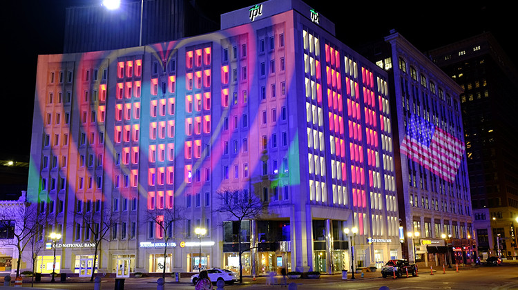 The Indianapolis Power & Light Company downtown headquarters is light up following a light display, Wednesday, March 25, 2020, in Indianapolis. The light display presentation illuminates love and hope to the world from the heart of Downtown Indianapolis. Gov. Eric Holcomb ordered state residents to remain in their homes to slow the spread of COVID-19.  - AP Photo/Darron Cummings