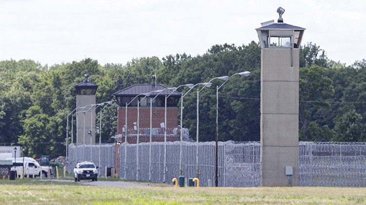 Office patrol the grounds of the federal prison in Terre Haute, Ind., is shown Monday, July 13, 2020.  - AP Photo/Michael Conroy