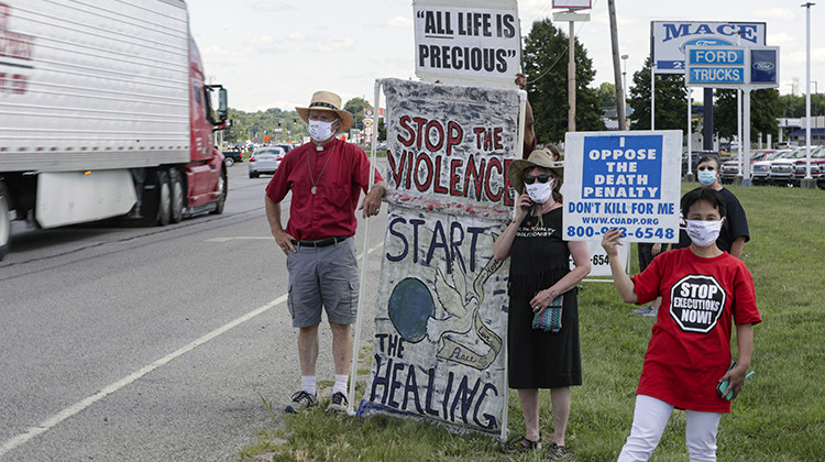 Protesters against the death penalty gather in Terre Haute, Ind., Monday, July 13, 2020. Daniel Lewis Lee, a convicted killer, was executed Tuesday morning in the federal prison in Terre Haute. He was convicted in Arkansas of the 1996 killings of gun dealer William Mueller, his wife, Nancy, and her 8-year-old daughter, Sarah Powell. - AP Photo/Michael Conroy