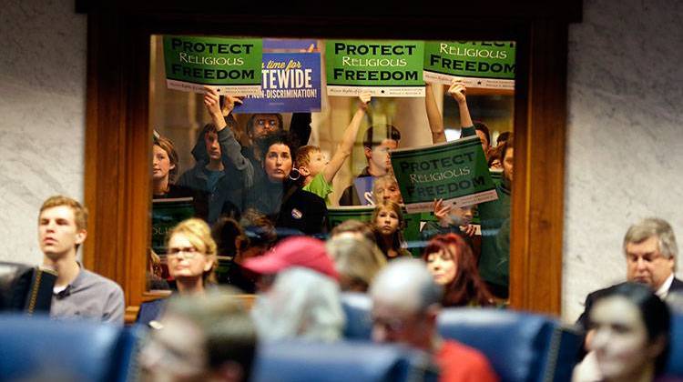 Supporters and protestors gather outside the Senate Chamber during a hearing on bills concerning LGBT civil rights and religious freedom at the Statehouse, Wednesday, Jan. 27, 2016. -  AP Photo/Michael Conroy