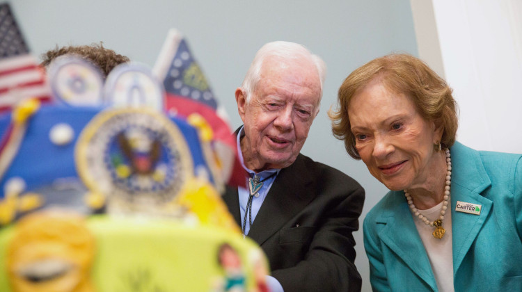 Former first lady Rosalynn Carter looks at a birthday cake with her husband, former President Jimmy Carter, during his 90th birthday celebration held at Georgia Southwestern University, Oct. 4, 2014, in Americus, Ga. - Branden Camp / AP