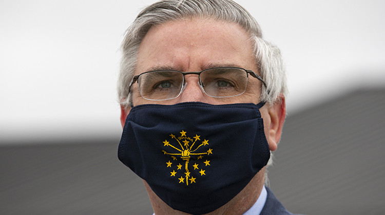 FILE - In this Thursday, April 30, 2020 file photo, Gov. Eric Holcomb wears a mask in Kokomo, Ind. - AP Photo/Michael Conroy, File