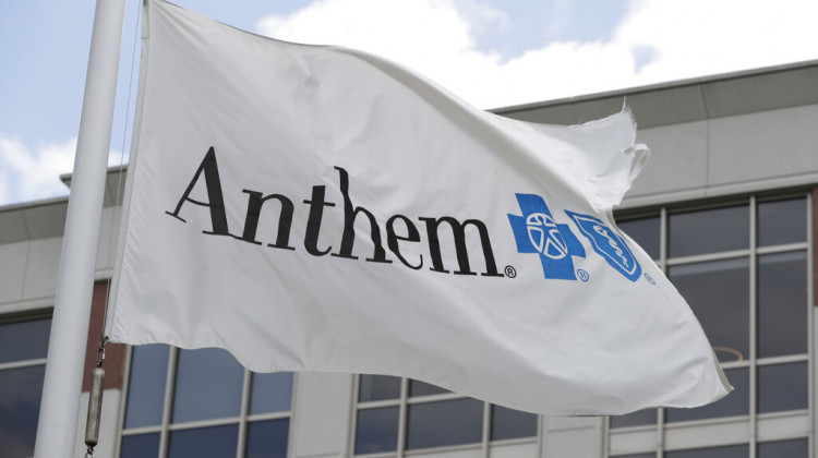FILE - In this May 14, 2019, file photo a flag flies the outside of the corporate headquarters building of health insurance company Anthem is shown in Indianapolis.  - AP Photo/Michael Conroy, File