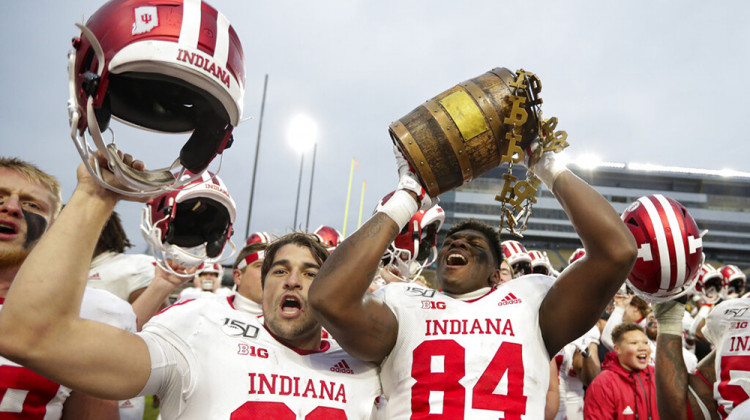 FILE - In this Nov. 30, 2019, file photo, Indiana tight end Turon Ivy Jr. (84) and place kicker Nathanael Snyder (99) celebrate with the Old Oaken Bucket following a football game against Big Ten and in-state rival Purdue in West Lafayette. The Big Ten said it plans to begin its season the weekend of Oct. 23-24. - AP Photo/Michael Conroy, File