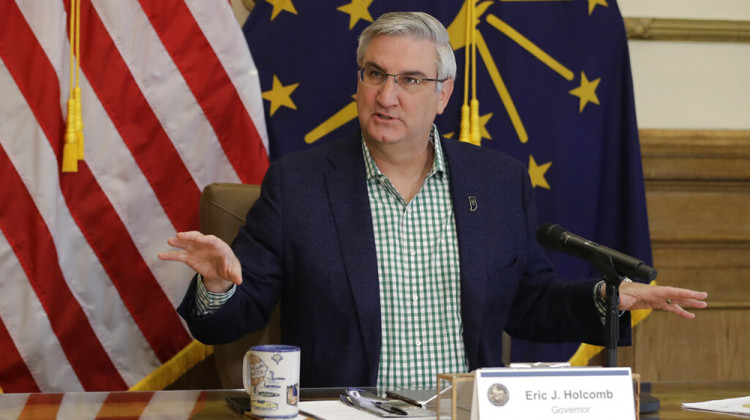 FILE - In this April 29, 2020, file photo, Indiana Gov. Eric Holcomb prepares to host a virtual media briefing in the Governor's Office at the Statehouse to provide updates on COVID-19 and its impact on Indiana, in Indianapolis. - AP Photo/Darron Cummings, File
