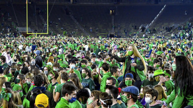 Fans storm the field after Notre Dame defeated the Clemson 47-40 in two overtimes in an NCAA college football game Saturday, Nov. 7, 2020, in South Bend, Ind.  - Matt Cashore/Pool Photo via AP