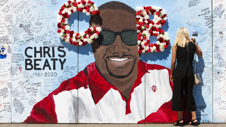 FILE - In this June 12, 2020 file photo, a mourner signs a tribute wall during a memorial service for former Indiana University football player Chris Beaty in Indianapolis. - AP Photo/Michael Conroy File