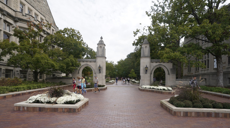 Students walk to classes on the Indiana University in Bloomington, Ind., in 2021. A student was stabbed on a bus near campus. - Darron Cummings / AP