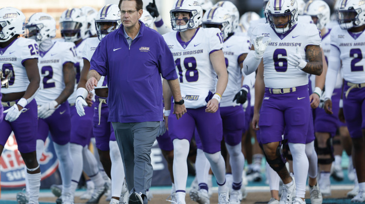 FILE - James Madison head coach Curt Cignetti leads his team onto the field before an NCAA college football game against Coastal Carolina in Conway, S.C., Saturday, Nov. 25, 2023. The Indiana Hoosiers are finalizing a deal to hire Curt Cignetti as their new football coach, two people with direct knowledge of the decision have told The Associated Press. - (AP Photo/Nell Redmond, File)