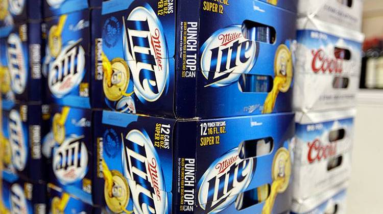 MIller Lite and Coots Light beers are shown in the aisles of Elite Beverages in Indianapolis, Monday, Jan. 28, 2013. - AP Photo/Michael Conroy