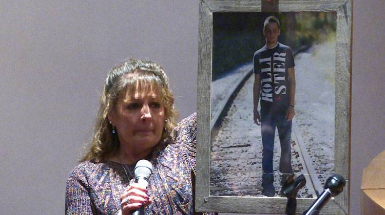 Barb Foley holds a photo of her son Kyle, who died from an overdose in July, while talking to students at Brown County High School. - Tyler Lake/WTIU