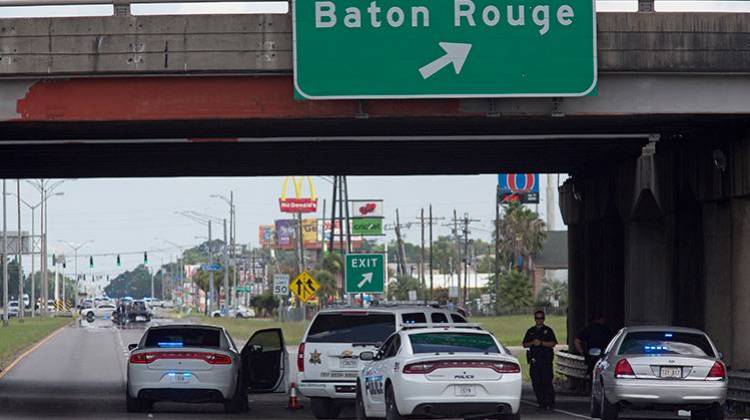 Baton Rouge Police block Airline Highway after police were shot in Baton Rouge, La., Sunday, July 17, 2016. At least three officers are confirmed dead and at least three others wounded after the shooting, a sheriff's office spokeswoman said Sunday. - AP Photo/Max Becherer