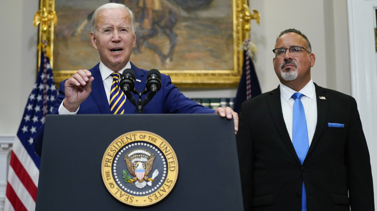 President Joe Biden speaks about student loan debt forgiveness in the Roosevelt Room of the White House, Wednesday, Aug. 24, 2022, in Washington. Education Secretary Miguel Cardona listens at right.  - AP Photo/Evan Vucci