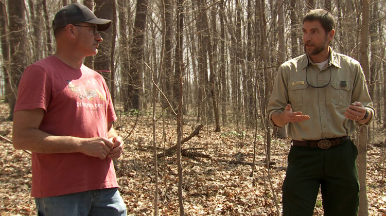 Hoosier National Forest Supervisor Mike Chaveas (right) talks with a southern Indiana resident about how the work on the project will happen over 10 years or more. - Devan Ridgway/WTIU