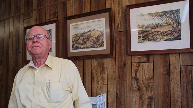 Earl Bullington, advisor for Focus Bank, which rescued the struggling Pemiscot County hospital in 2013. The pictures on his wall depict the farmland in Pemiscot County, Missouri. - Bram Sable-Smith/KBIA/Side Effects Public Media