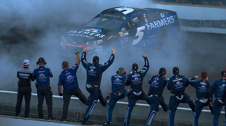 Members of Kasey Kahne's pit crew celebrate as Kahne performs a burnout following his win in the Brickyard 400 Sunday, July 23 at the Indianapolis Motor Speedway. - Doug Jaggers/WFYI
