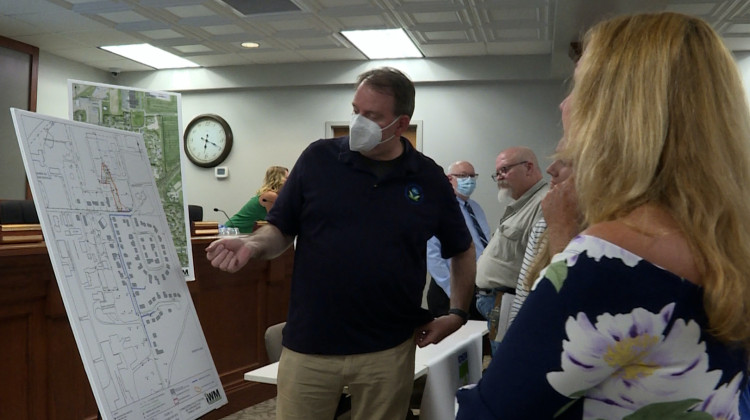 Chris Black with the EPA answers questions from Franklin residents in front of a map of the contaminated area at a public meeting on June 9. - Rebecca Thiele/IPB News