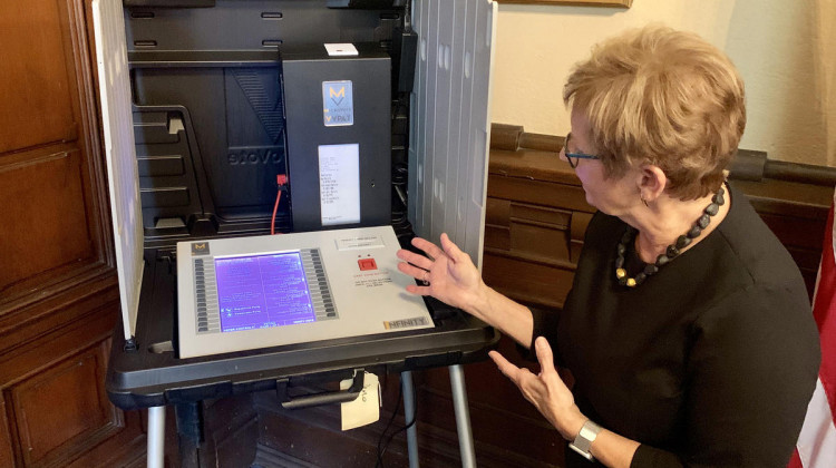 Secretary of State Connie Lawson demonstrates the use of a paper audit trail on an electronic voting machine. - Brandon Smith/IPB News