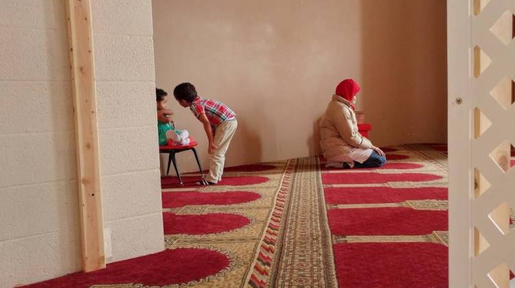alia Mohamed prays before an interview at the Islamic Society of Columbus, Indiana, while her kids, 2-year-old Selma and 5-year-old Mohamed, play nearby. - Annie Ropeik/IPB News
