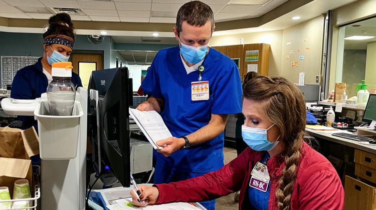 Nurses Matt Ippel and Kelsey Coffin review cases at Pine Rest Christian Mental Health Services. The Grand Rapids facility treats children and adults with mental health issues. - (Erin Kirkland/Bridge Michigan)